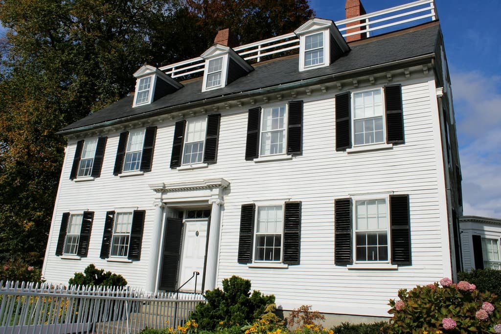 Classic white New England colonial with black shutters